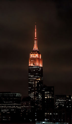 The Empire State Building lit up in orange